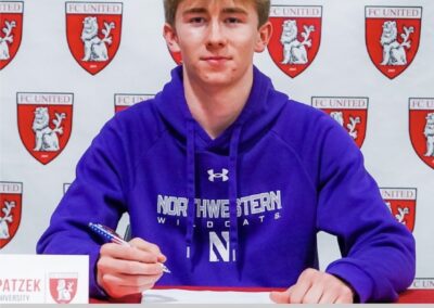A man in northwestern sweatshirt sitting at a table.